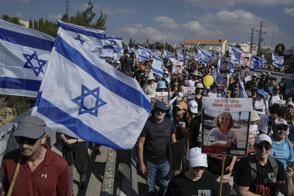 Family and supporters of the estimated 240 hostages held by Hamas in Gaza complete the final leg of a five-day solidarity rally calling for their return, from Tel Aviv to the Prime Minister's office in Jerusalem, in the town of Mevaseret Zion, near Jerusalem, Saturday, Nov. 18, 2023. The hostages, mostly Israeli citizens, were abducted during the brutal Oct. 7 Hamas cross-border attack in Israel and have been held in the enclave since as war rages. (AP Photo/Leo Correa)