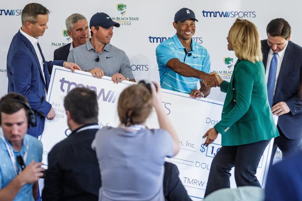 Tiger Woods, center, is seen here with Palm Beach State College President Ava Parker, right, and TGL co-founder Rory McIlroy, left, during a donation presentation Feb. 20, 2023 at PBSC's Palm Beach Gardens campus. Collapse of TGL's dome on the campus has delayed the start of the league. "Although the events of last week will force us to make adjustments to our timelines, I’m fully confident that this concept will be brought to life by our great committed players," Woods said.