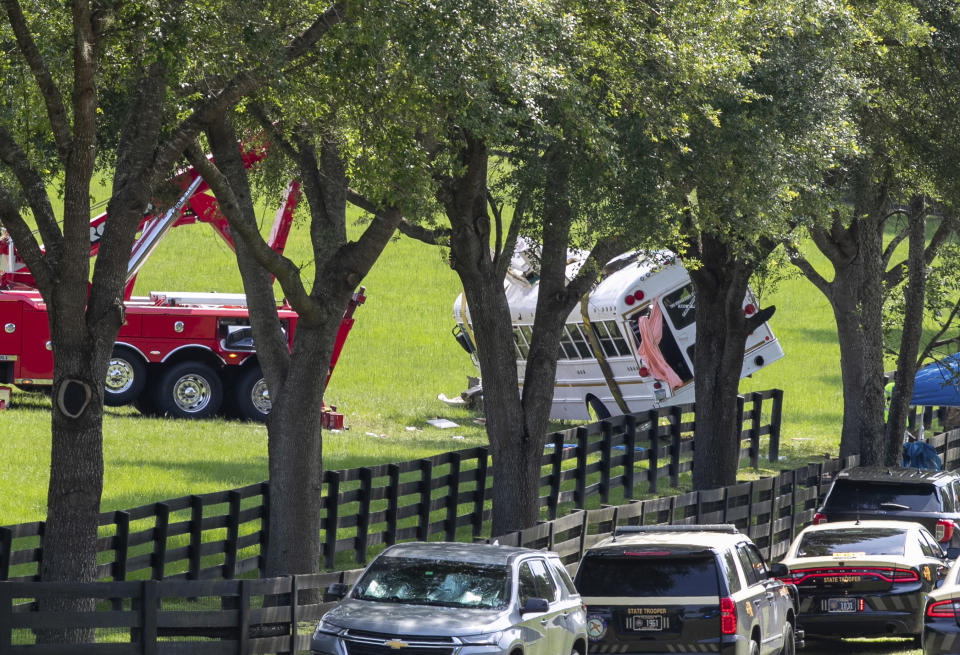 Authorities work at the scene of a deadly crash after a bus carrying farmworkers collided with a pickup truck on State Road 40 Tuesday, May 14, 2024, near Dunnellon, Fla. The driver of the pick up, Bryan Maclean Howard, was charged with eight counts of DUI manslaughter. (AP Photo/Alan Youngblood)