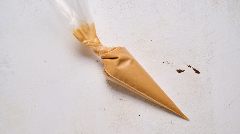melted peanut butter in piping bag