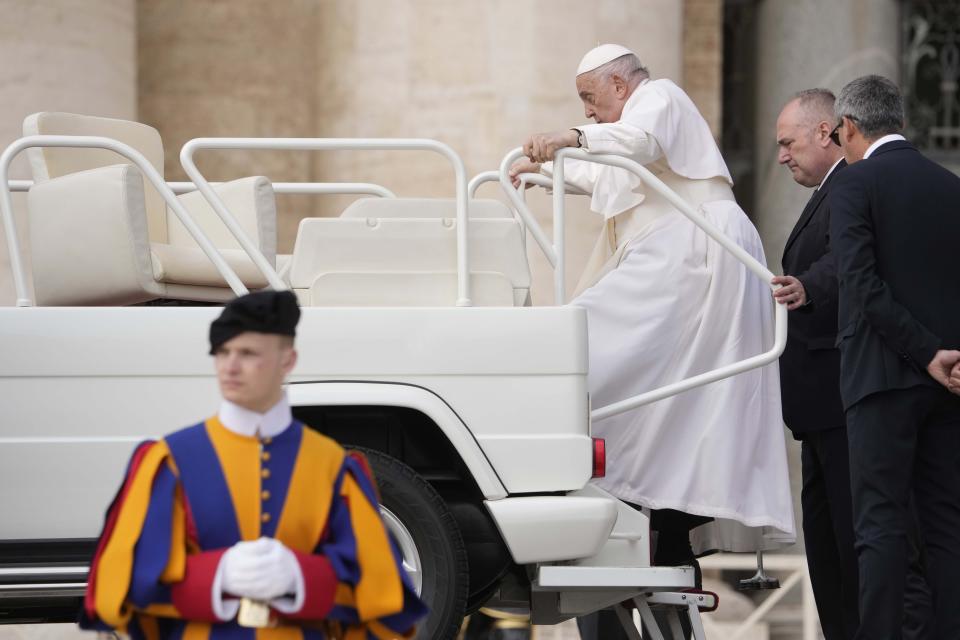Pope Francis climbs on the popemobile after his weekly general audience in St. Peter's Square at The Vatican, Wednesday, April 10, 2024. (AP Photo/Andrew Medichini)