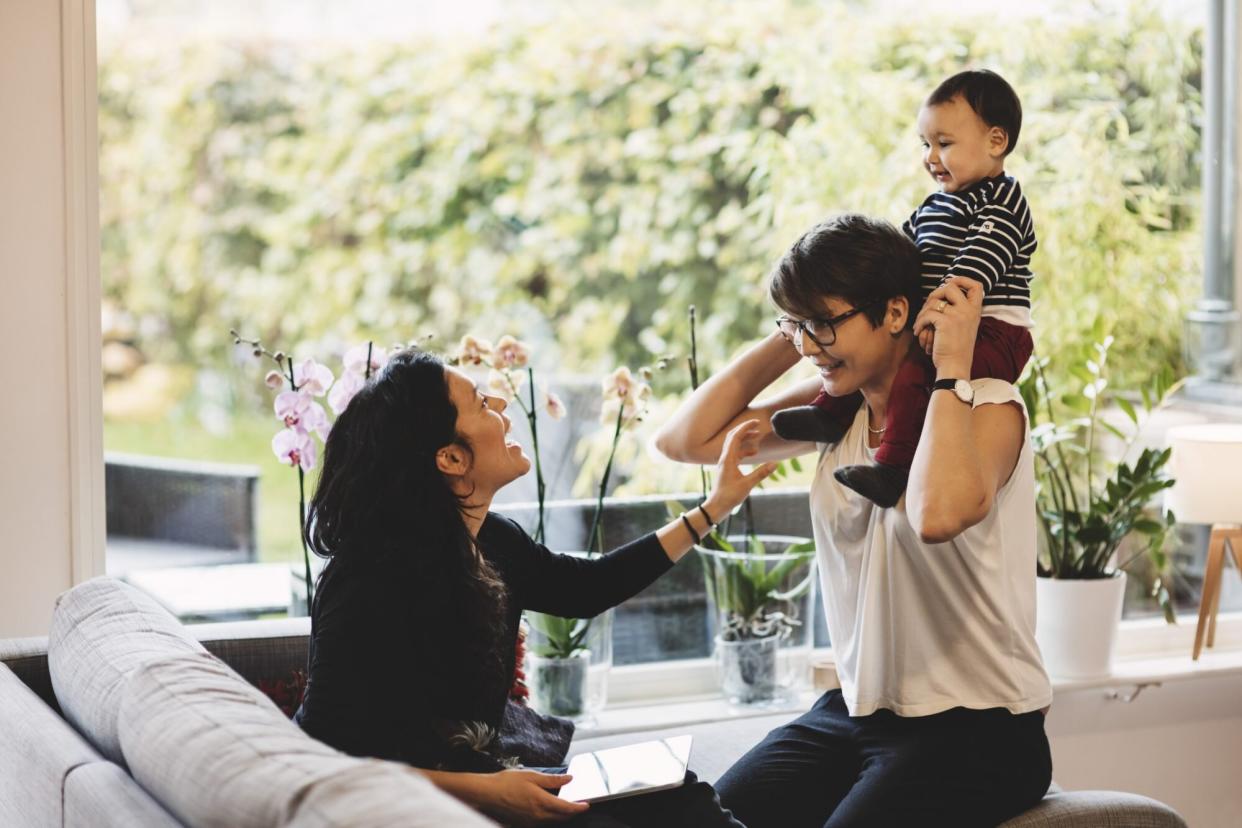 two parents playing with baby