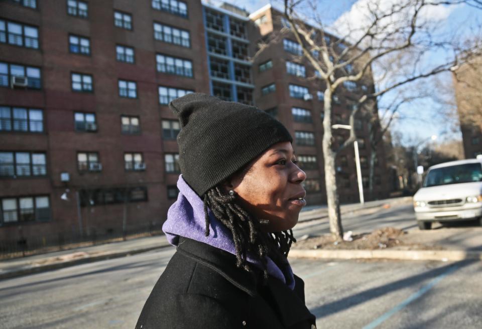 Naquasia LeGrand sits walks through a parking lot at the apartment complex where she lives in the Carnarsie section of Brooklyn, on Thursday Feb. 27, 2014 in New York. A few months ago, LeGrand was just another worker on the line at KFC, boxing up chicken and cole slaw in hopes of earning enough to live in one of the nation's most expensive cities. But since being recruited by union organizers, the 22-year-old from south Brooklyn has become one of the most visible faces of a national movement demanding $15-an-hour wages for fast-food workers. (AP Photo/Bebeto Matthews)