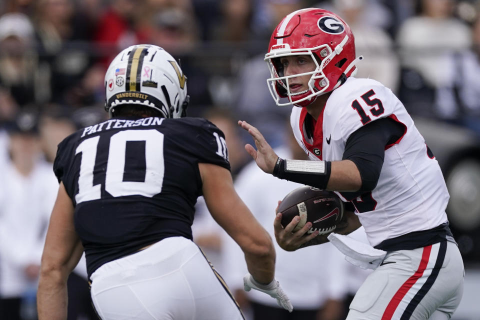 Georgia quarterback Carson Beck (15) runs the ball past Vanderbilt linebacker Langston Patterson (10) in the second half of an NCAA college football game Saturday, Oct. 14, 2023, in Nashville, Tenn. (AP Photo/George Walker IV)