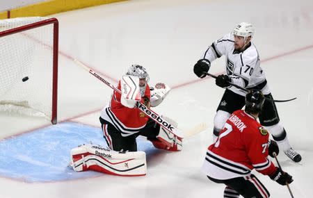 Jun 1, 2014; Chicago, IL, USA; Los Angeles Kings left wing Tanner Pearson (70) chases after the puck between Chicago Blackhawks defenseman Brent Seabrook (7) and goalie Corey Crawford during the overtime period in game seven of the Western Conference Final of the 2014 Stanley Cup Playoffs at United Center. Mandatory Credit: Dennis Wierzbicki-USA TODAY Sports