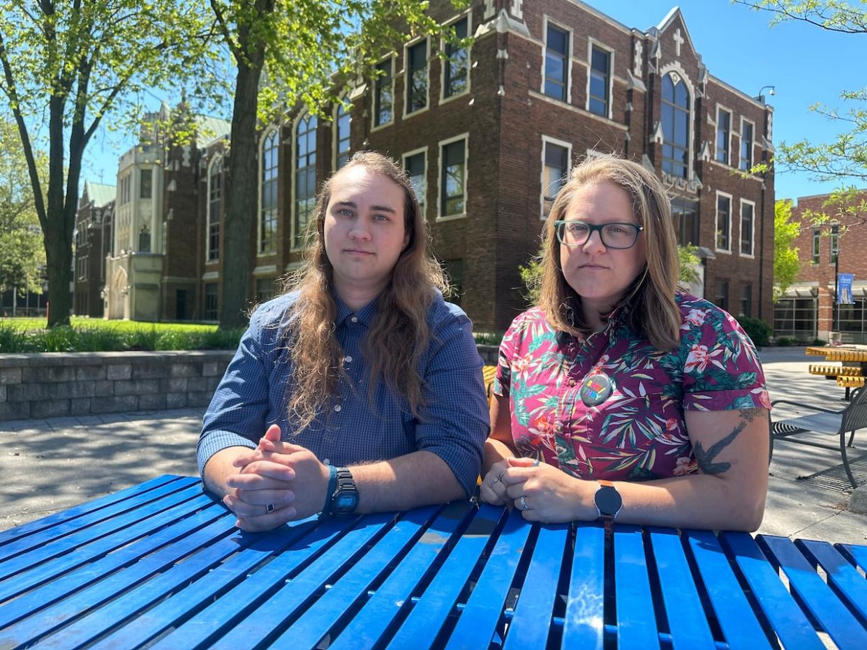 Mack Park, right, is a masters' student and staff member at the University of Windsor. They also co-chair the school's Pride Committee. Ashlyne O'Neil, left, also co-chair's the Pride Committee and is a faculty member in the Office of Open Learning. (Jennifer La Grassa/CBC - image credit)