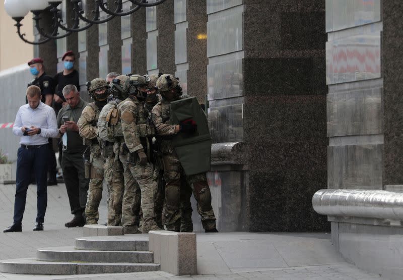 Members of a Ukrainian special forces unit are seen outside a building where an unidentified man reportedly threatens to blow up a bomb in a bank branch, in Kyiv