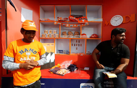 Workers sell masks of India’s Prime Minister Narendra Modi, and mugs and T-shirts featuring India’s ruling Bharatiya Janata Party (BJP) outside the venue of an election rally by BJP in Meerut in the northern Indian state of Uttar Pradesh, India, March 28, 2019. REUTERS/Adnan Abidi