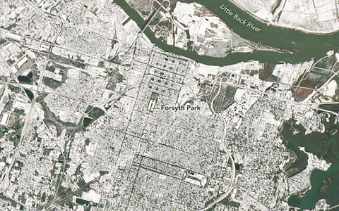 A Nasa satellite image shows the city of Savannah, Georgia, covered in snow from a "bomb cyclone" - Credit: Nasa via AFP