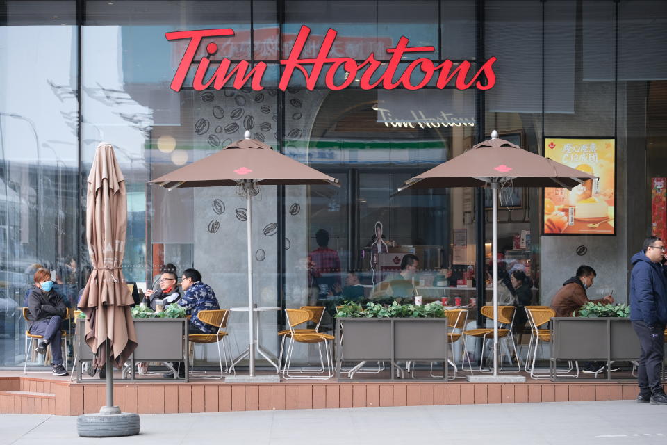 Shanghai,China-March 6th 2022: Chinese customers sitting at Tim Hortons coffee store. Facade of Tim Hortons brand logo