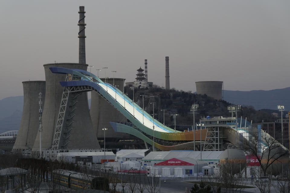 The Big Air Shougang course is illuminated at dusk in Beijing, China, Tuesday, Jan. 11, 2022. The venue will host the big air competition during the upcoming 2022 Beijing Winter Olympics. (AP Photo/Ng Han Guan)