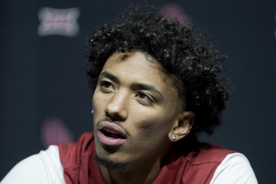 Oklahoma's Milos Uzan talks to the media during the NCAA college Big 12 men's basketball media day Wednesday, Oct. 18, 2023, in Kansas City, Mo. (AP Photo/Charlie Riedel)