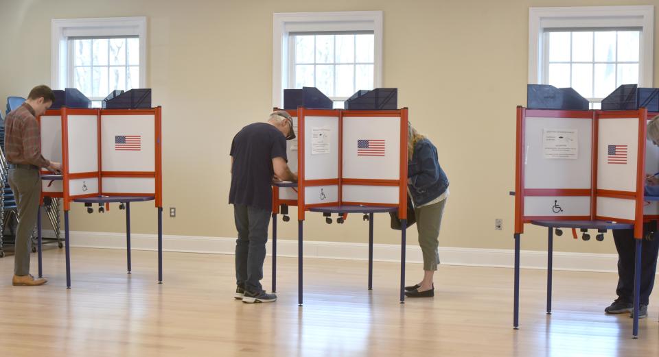 Voters cast their ballots in the booths at the Dennis Senior Center for Precinct 2 in the town election on Tuesday.