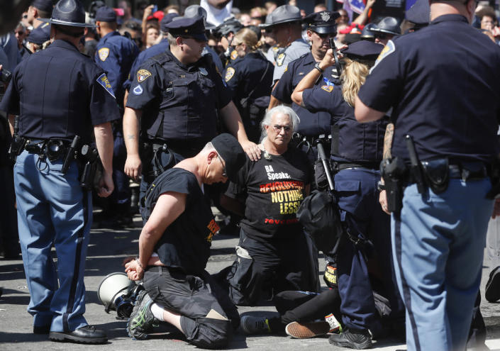 <p>Law enforcement officers take protesters into custody, July 20, 2016, in Cleveland, during the third day of the Republican convention. (Photo: John Minchillo/AP)</p>