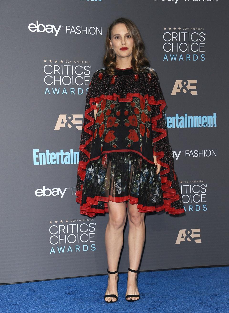 <p>This caped Alexander McQueen dress has to be one of Natalie’s best looks of all time. Boasting a tiered design and a striking floral print, it completely took the attention away from the star’s bump and was a fantastic style statement. [Photo: Getty] </p>