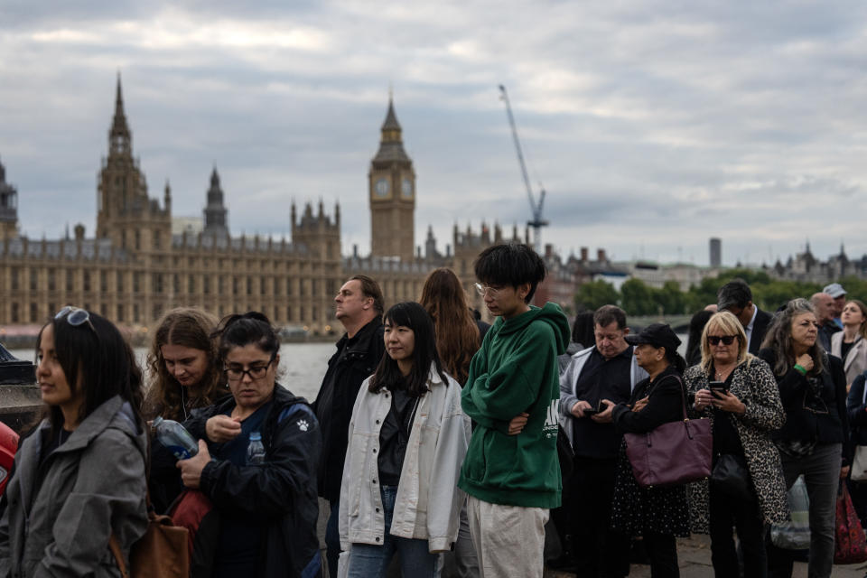 LONDON, ENGLAND - SEPTEMBER 15: People queue to visit the Palace of Westminster where the body of Queen Elizabeth II is lying in state on September 15, 2022 in London, United Kingdom. Queen Elizabeth II is lying in state at Westminster Hall until the morning of her funeral to allow members of the public to pay their last respects. Elizabeth Alexandra Mary Windsor was born in Bruton Street, Mayfair, London on 21 April 1926. She married Prince Philip in 1947 and acceded to the throne of the United Kingdom and Commonwealth on 6 February 1952 after the death of her Father, King George VI. Queen Elizabeth II died at Balmoral Castle in Scotland on September 8, 2022, and is succeeded by her eldest son, King Charles III. (Photo by Carl Court/Getty Images)