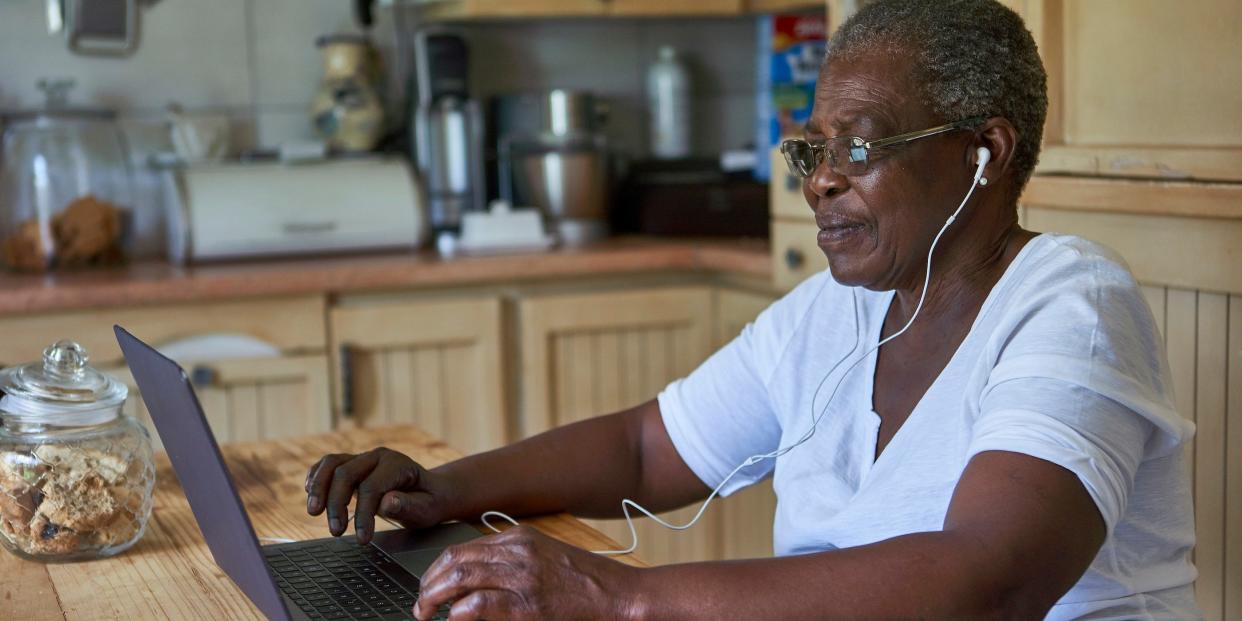 senior woman using laptop computer at home