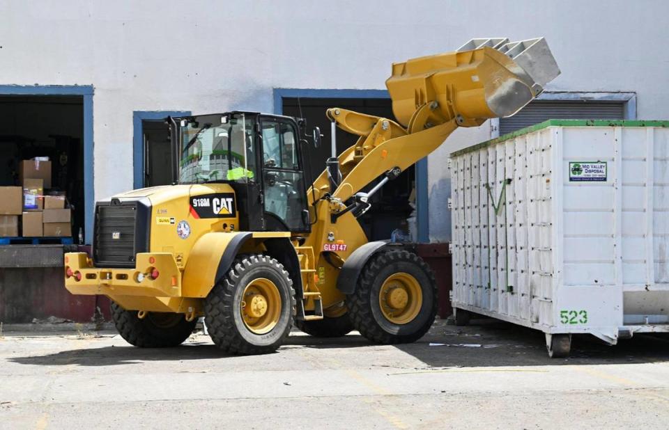 Office cases are dumped as the cleanup process continues at the closed warehouse location which had been illegally operated by Chinese company Prestige Biotech, seen Tuesday, August 1, 2023 in Reedley.