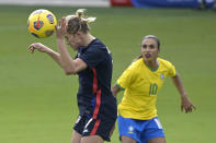 United States defender Abby Dahlkemper (7) heads a ball in front of Brazil midfielder Marta (10) during the first half of a SheBelieves Cup women's soccer match, Sunday, Feb. 21, 2021, in Orlando, Fla. (AP Photo/Phelan M. Ebenhack)