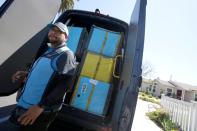 Joseph Alvarado opens the back of the van as he makes deliveries for Amazon during the outbreak of the coronavirus disease