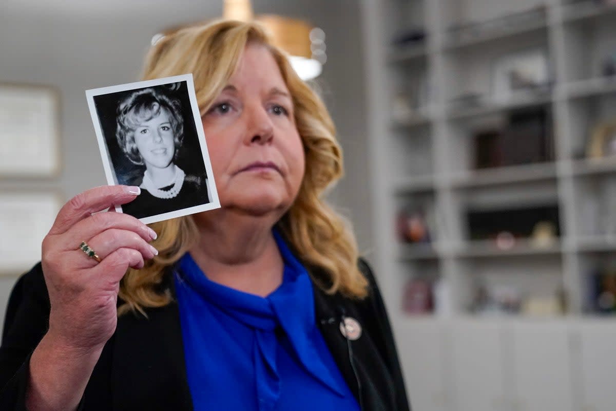 Nassau County district attorney Anne Donnelly shows a photo of Diane Cusick on 22 June (AP)