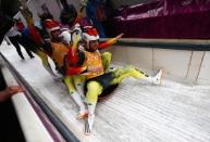 Felix Loch, Tobias Wendl, Natalie Geisenberger and Tobias Arlt of Germany celebrate winning the Luge Relay on Day 6 of the Sochi 2014 Winter Olympics