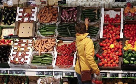 A woman checks vegetables at the Biocompany organic supermarket in Berlin, January 31, 2013. REUTERS/Fabrizio Bensch