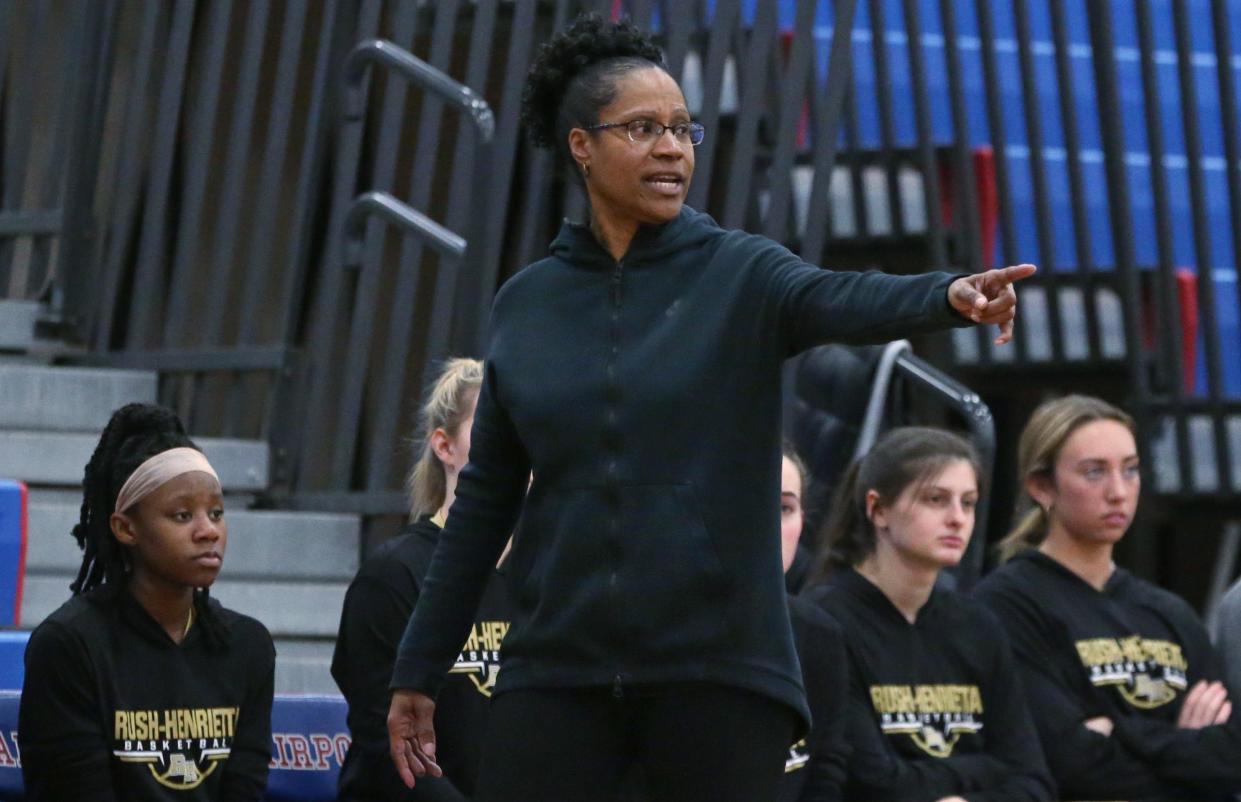 Rush Henrietta Royal Comets head coach Renee Long calls in a defensive play.