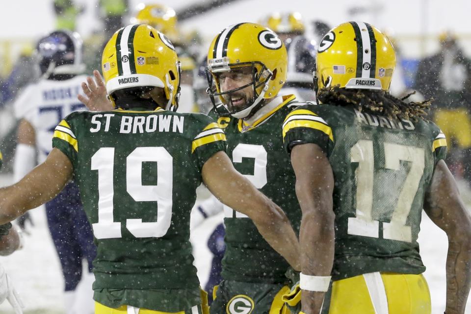 Green Bay Packers' Equanimeous St. Brown celebrates his touchdown catch with Aaron Rodgers (12) and Davante Adams (17) during the first half of an NFL football game against the Tennessee Titans Sunday, Dec. 27, 2020, in Green Bay, Wis. (AP Photo/Mike Roemer)