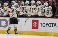 Vegas Golden Knights center Michael Amadio (22) is congratulated by teammates after scoring a goal during the second period of an NHL hockey game against the Washington Capitals, Monday, Jan. 24, 2022, in Washington. (AP Photo/Evan Vucci)