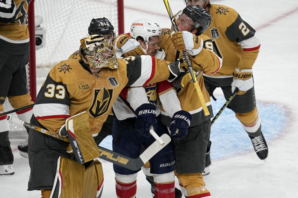 Vegas Golden Knights goaltender Adin Hill (33) and center Jack Eichel (9) throw punches at Florida Panthers center Nick Cousins swings during the first period of Game 1 of the NHL hockey Stanley Cup Finals, Saturday, June 3, 2023, in Las Vegas. (AP Photo/Abbie Parr)