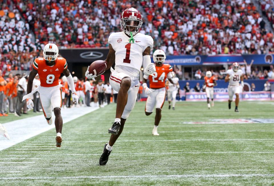 Sep 4, 2021; Atlanta, Georgia, USA;  Alabama wide receiver Jameson Williams (1) dances into the end zone with a long touchdown from Alabama quarterback Bryce Young (9) at Mercedes-Benz Stadium. Alabama defeated Miami 44-13. Mandatory Credit: Gary Cosby-USA TODAY Sports