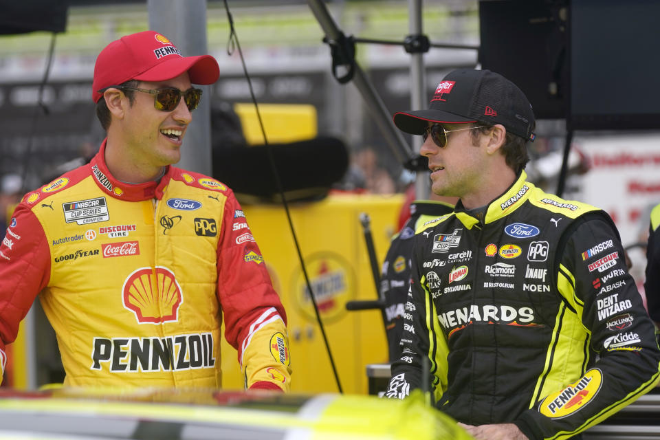 Joey Logano, left, and Ryan Blaney chat before qualifying for the NASCAR All-Star auto race at Texas Motor Speedway in Fort Worth, Texas, Saturday, May 21, 2022. (AP Photo/LM Otero)