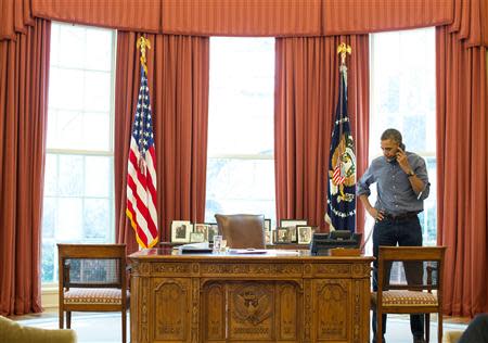 President Barack Obama talks on the phone in the Oval Office with Russian President Vladimir Putin about the situation in Ukraine