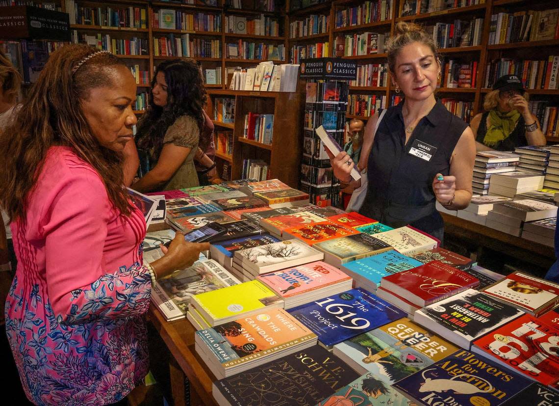 Educator Nancy St. Leger, left, and author Rebekah Shoaf, right, check out some of the banned books displayed during the “Walk for Freadom” kickoff event on Sunday, October 1, 2023 in Coral Gables, Florida. The march began at the Coral Gables Congregational United Church of Christ and ended at Books & Books.