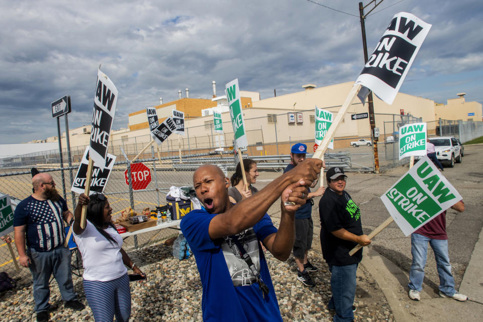 Flint resident Jashanti Walker, who has been a first shift team leader in the body shop for two years, demonstrates with more than a dozen other General Motors employees outside of the Flint Assembly Plant on Sunday, Sept. 15, 2019, in Flint, Mich. The United Auto Workers union says its contract negotiations with GM have broken down and its members will go on strike just before midnight on Sunday. (Jake May/The Flint Journal via AP)