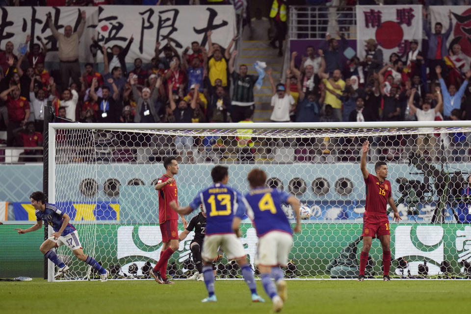 Spain's Rodri (16) gestures towards the lineman after Japan's Ao Tanaka, left, scored a goal during the World Cup group E soccer match between Japan and Spain, at the Khalifa International Stadium in Doha, Qatar, Thursday, Dec. 1, 2022. (AP Photo/Aijaz Rahi)