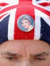 <p>Royalist John Loughrey wears a Princess Diana badge on his Union Jack hat as people pay tribute at the gates of Kensington Palace on the 20th anniversary of the death of Princess Diana at Kensington Palace on Aug. 31, 2017 in London, England. (Photo: Chris Jackson/Getty Images) </p>