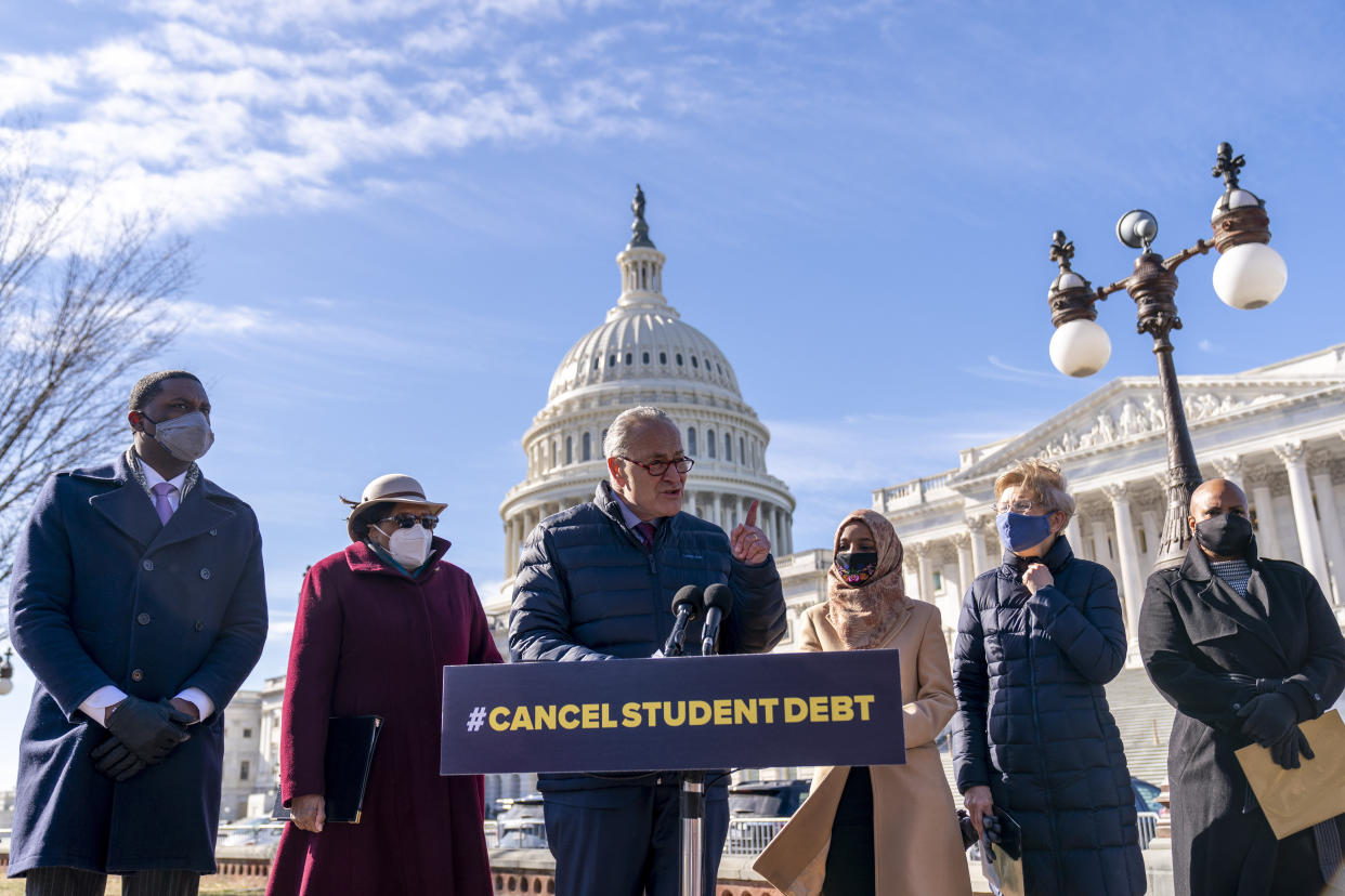 Senate Majority Leader Sen. Chuck Schumer, center, accompanied by, from left, Rep. Mondaire Jones, D-N.Y., Rep. Alma Adams, D-N.C., Rep. Ilhan Omar, D-Minn., Sen. Elizabeth Warren, D-Mass., and Rep. Ayanna Pressley, D-Mass., speaks at a news conference on Capitol Hill on Feb. 4, 2021, about plans to reintroduce a resolution to call on President Biden to take executive action to cancel up to $50,000 in debt for federal student loan borrowers.