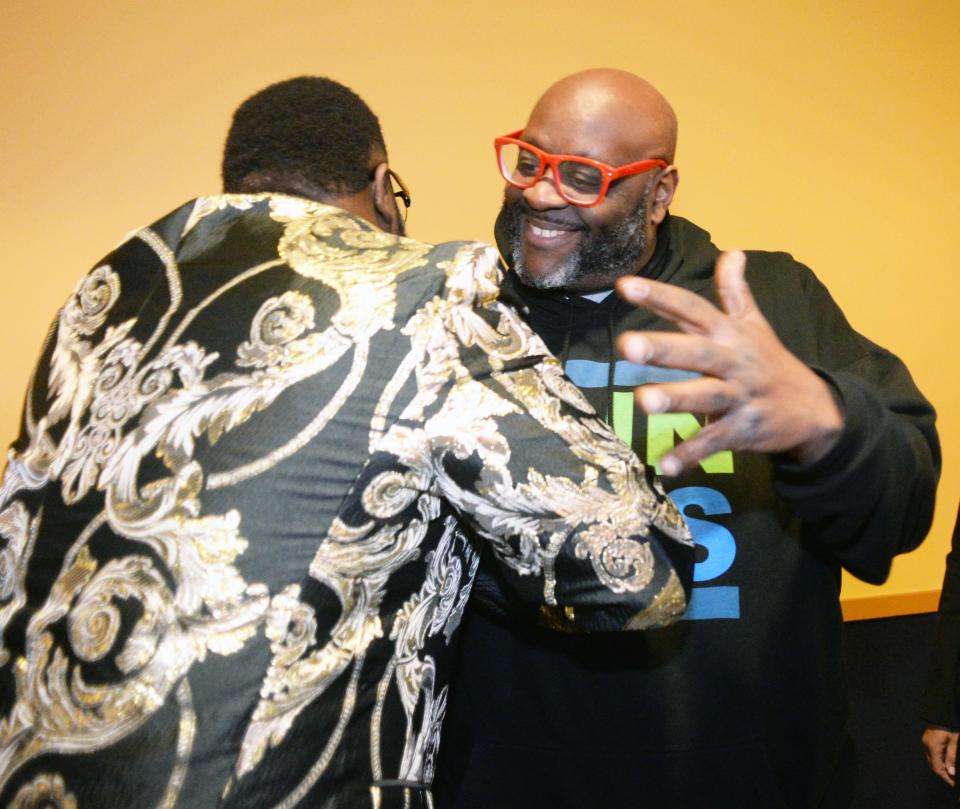 Brockton resident Ollie Spears, right, greets Brockton native Noube Rateau, left, as he premieres his "I Am You" documentary at Showcase Cinema de Lux at Patriot Place in Foxboro on Thursday, March 24, 2022.