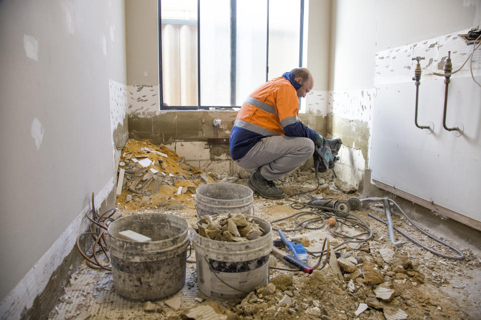 Tradie performing renovations to a bathroom and laundry.