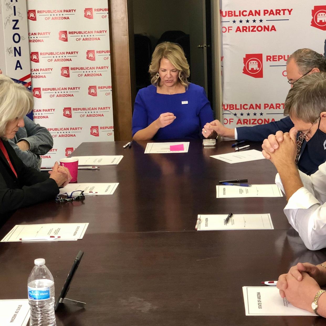 A photo posted on Twitter by the Republican Party of Arizona showed the electors sitting in prayer before casting their votes for Donald Trump on Dec. 14, 2020. Despite Joe Biden winning Arizona, the Republicans filed documents with Congress falsely claiming to be Arizona's true electors.