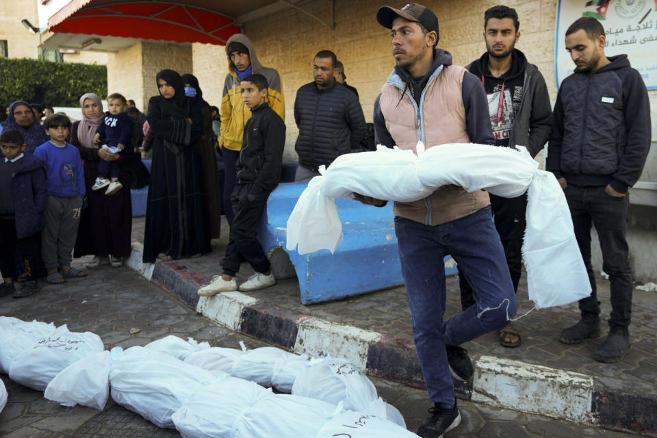 Palestinians mourn their relatives killed in the Israeli bombardment of the Gaza Strip in Deir al Balah, Monday, Feb. 5, 2024. (AP Photo/Adel Hana)
