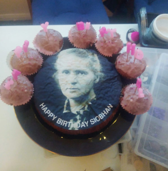 Photo of a black and white image of Marie Curie on a cake that was supposed to have Mariah Carey.