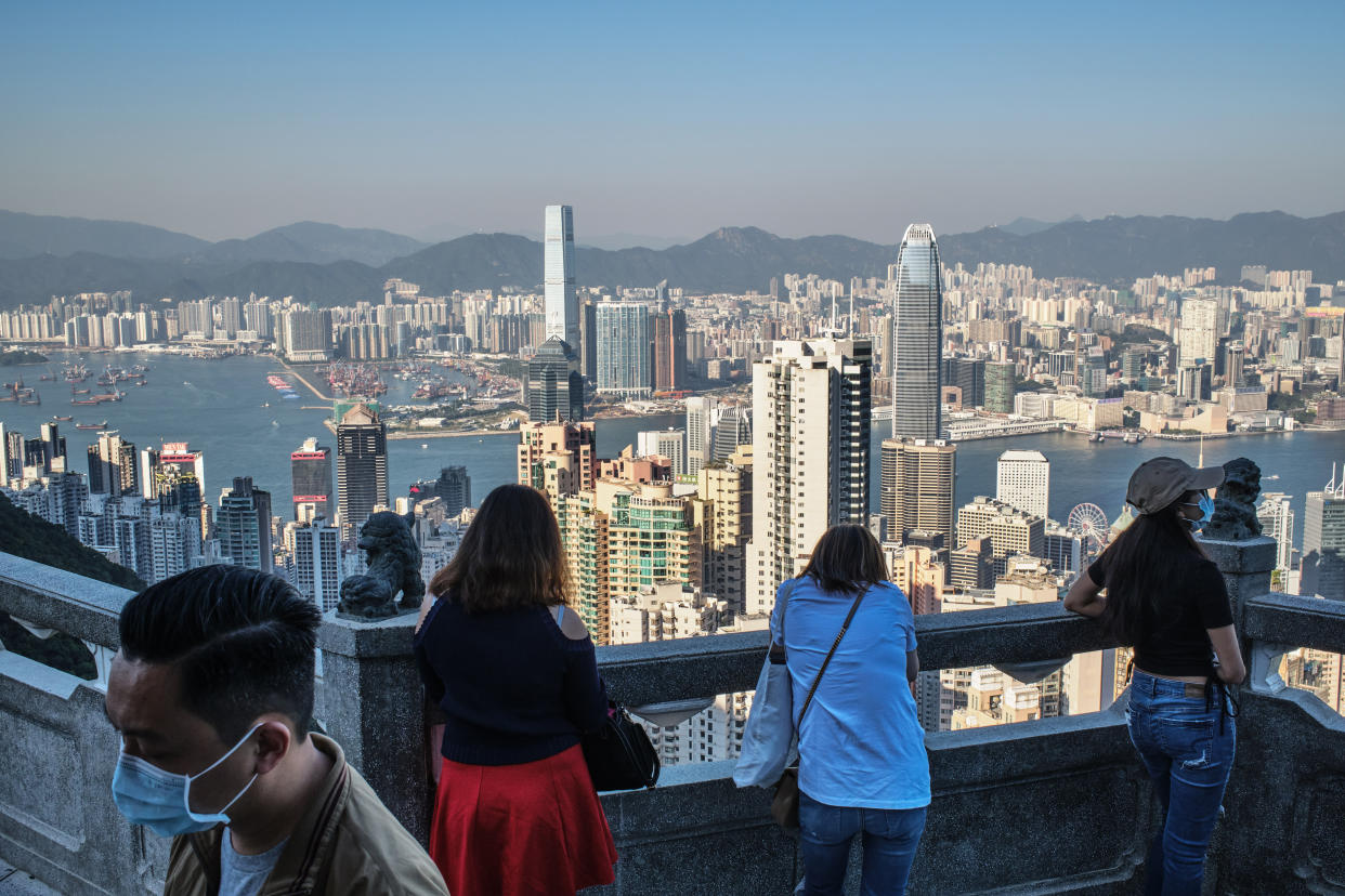 HONG KONG, CHINA - 2020/11/12: Visitors look at the skyline of Hong Kong from Victoria peak, a typically busy tourist attraction. (Photo by Isaac Wong/SOPA Images/LightRocket via Getty Images)