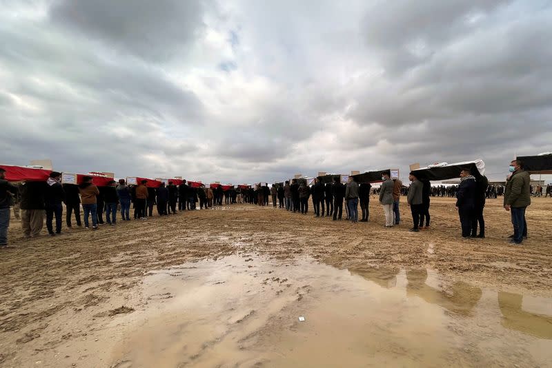 FILE PHOTO: Burial of victims killed by Islamic State after bodies' exhumation from mass graves in Kojo