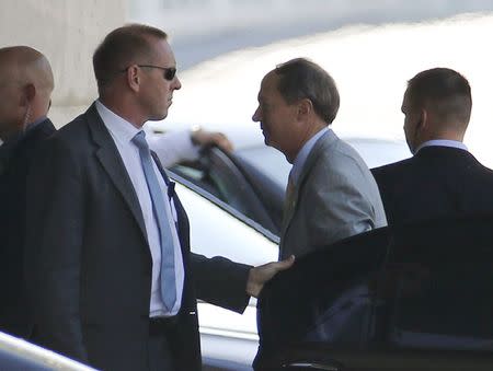 U.S. Ambassador John Emerson to Germany (2nd R) is surrounded by body guards as he arrives at the Chancellery in Berlin, Germany, July 2, 2015. REUTERS/Fabrizio Bensch