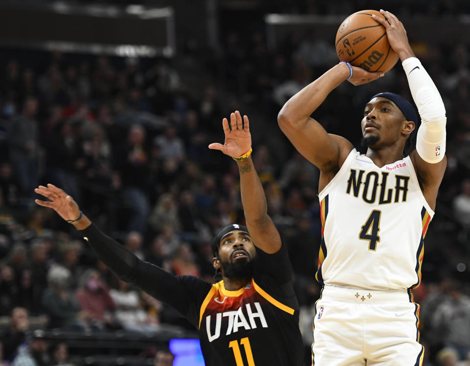 New Orleans Pelicans guard Devonte' Graham (4) shoots next to Utah Jazz guard Mike Conley (11) during the second half of an NBA basketball game Friday, Nov. 26, 2021, in Salt Lake City. (AP Photo/Alex Goodlett)