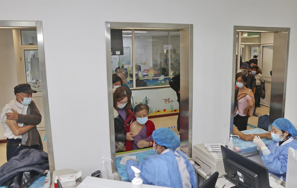 FILE - Elderly residents get vaccinated against COVID-19 at a community health center in Nantong in eastern China's Jiangsu province on Dec. 9, 2022. China's sudden reopening after two years holding to a "zero-COVID" strategy left older people vulnerable and hospitals and pharmacies unprepared during the season when the virus spreads most easily, leading to many avoidable deaths, The Associated Press has found. (Chinatopix Via AP)