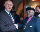 FILE - Truth Commission chairman and Anglican Archbishop Emeritus Desmond Tutu, right, shakes hands with Former South African President P.W. Botha, left, Thursday, Nov. 21 1996 at the Wilderness, South Africa. Tutu, South Africa’s Nobel Peace Prize-winning activist for racial justice and LGBT rights and retired Anglican Archbishop of Cape Town, has died, South African President Cyril Ramaphosa announced Sunday Dec. 26, 2021. He was 90. (AP Photo/Benny Gool, File)